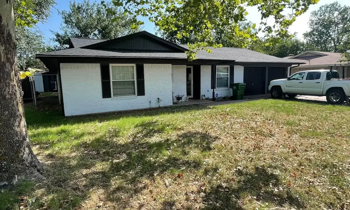 Professional roofing crew working on a residential roof in Isanti
